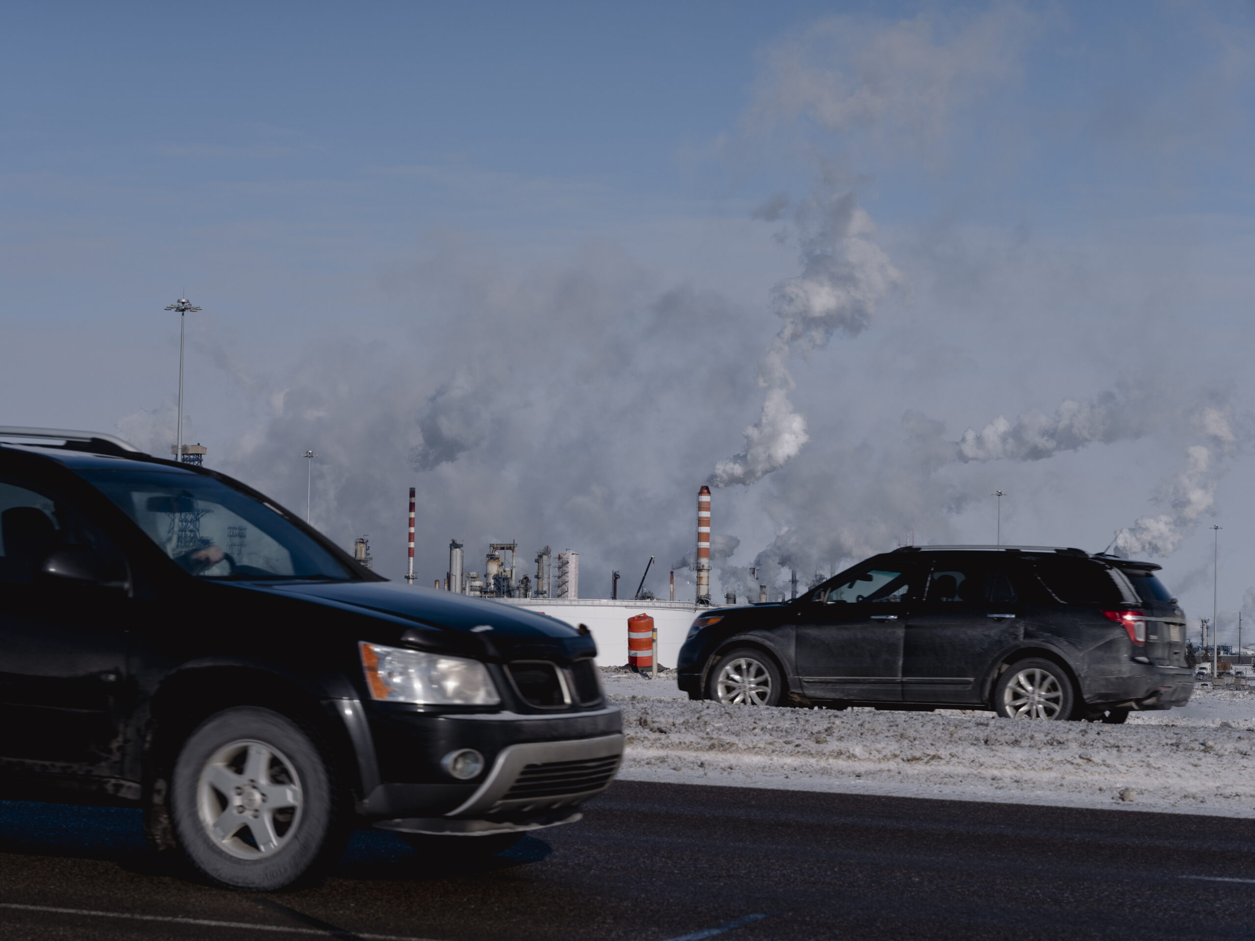 Cars pass by refineries near Edmonton.