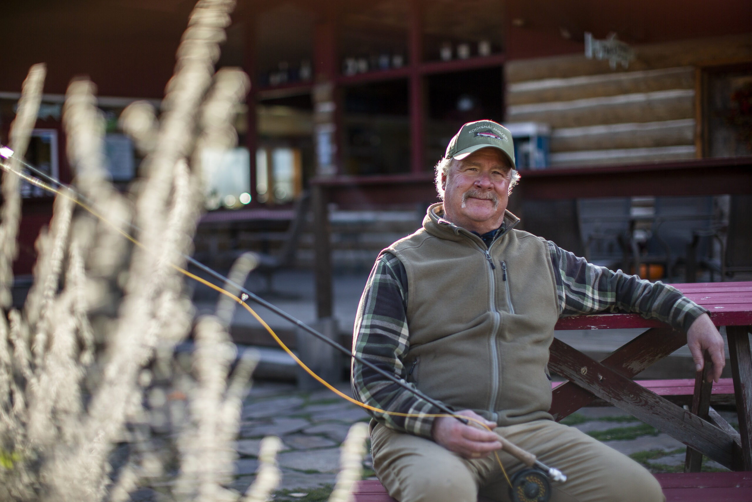 River guide Dave Blackburn sits outside his fly fishing shop near the Kootenay River