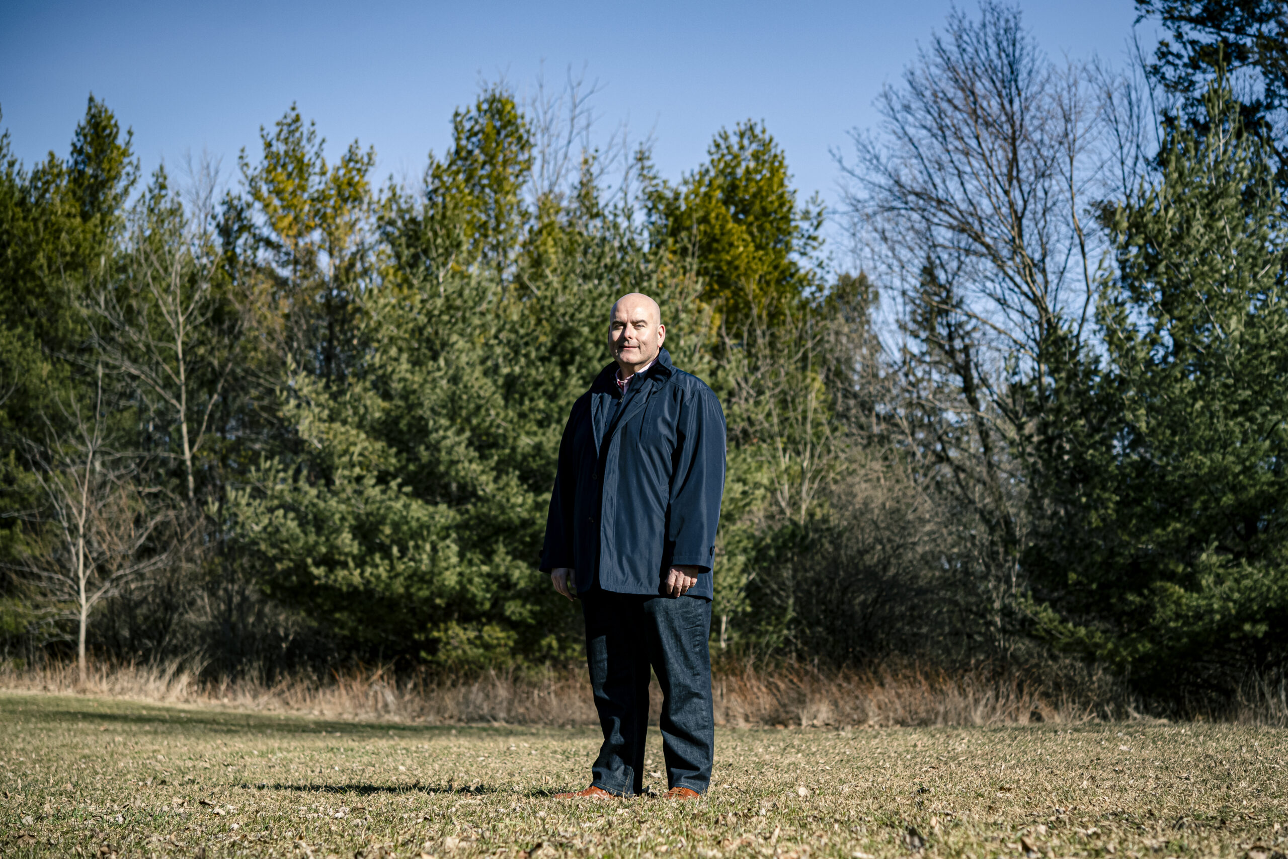 Ontario Liberal leader Steven Del Duca stands in a field in a the sun in front of trees and a clear sky. His environment plan for the 2022 Ontario election hasn't been released yet.
