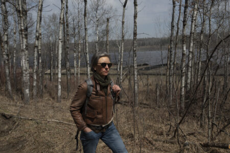 Kristine Kowalchuk walks past Epcor's solar panel in the Edmonton river valley.