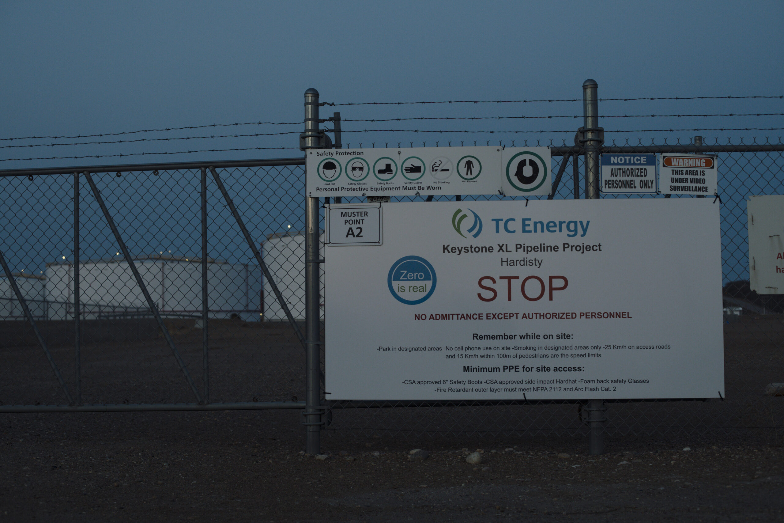 A barbed-wire fence with a sign that reads Keystone XL Pipeline Project, no admittance except authorized personnel.