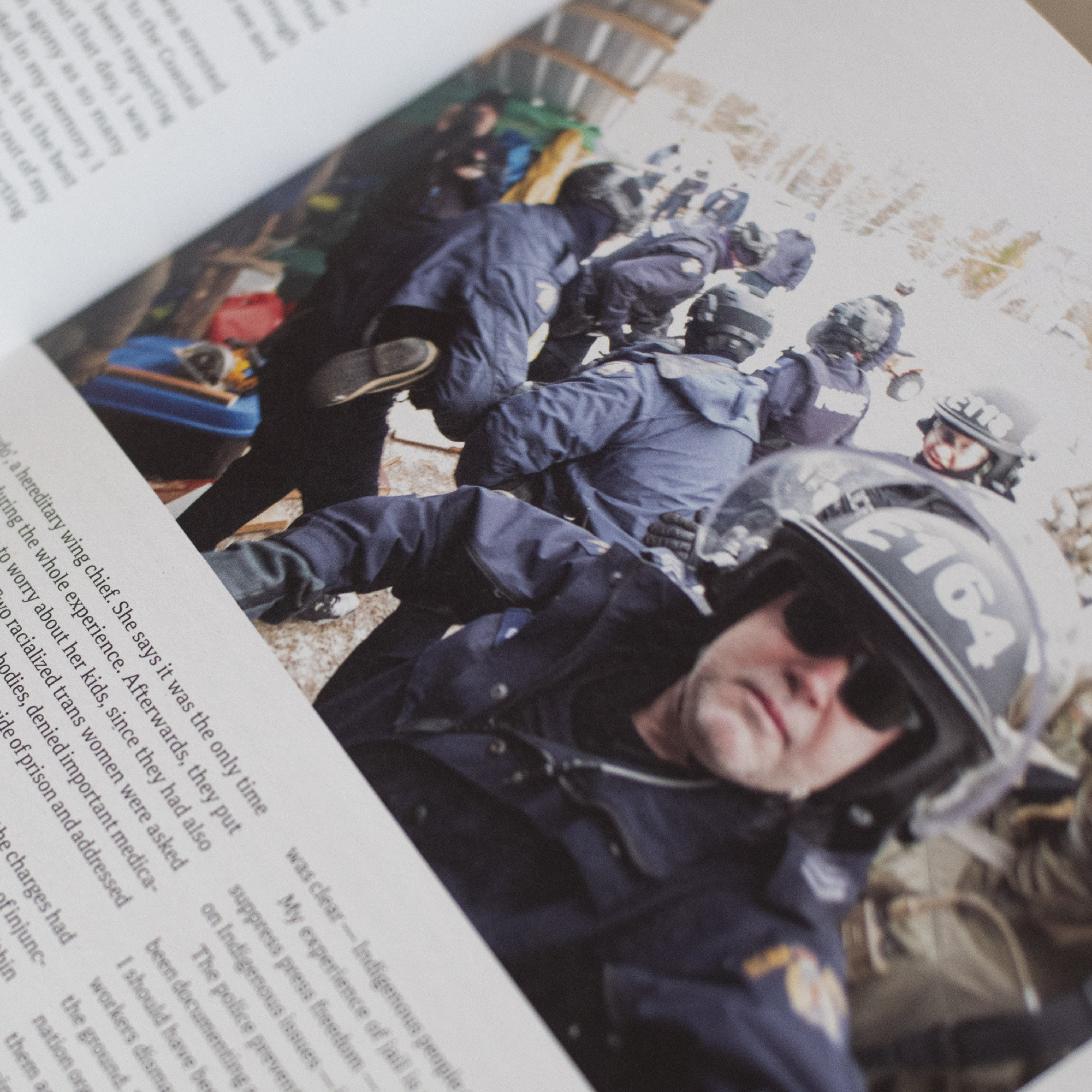 A spread from our print edition, with a photo of RCMP officers conducting arrests.