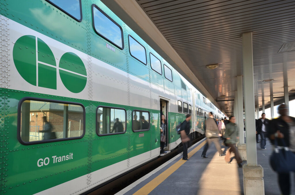 People getting off a GO Train at a station in 2014