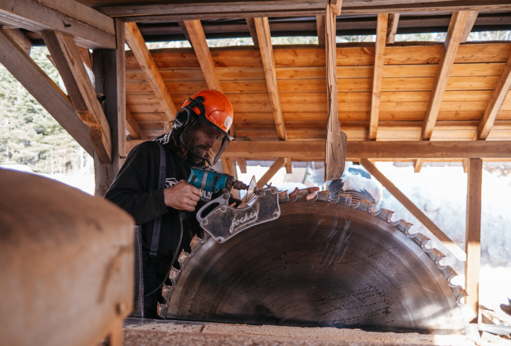 Shilo Freer sharpens the saw blade on Son Ranch Timber Co.'s 1930s-era head saw mill.