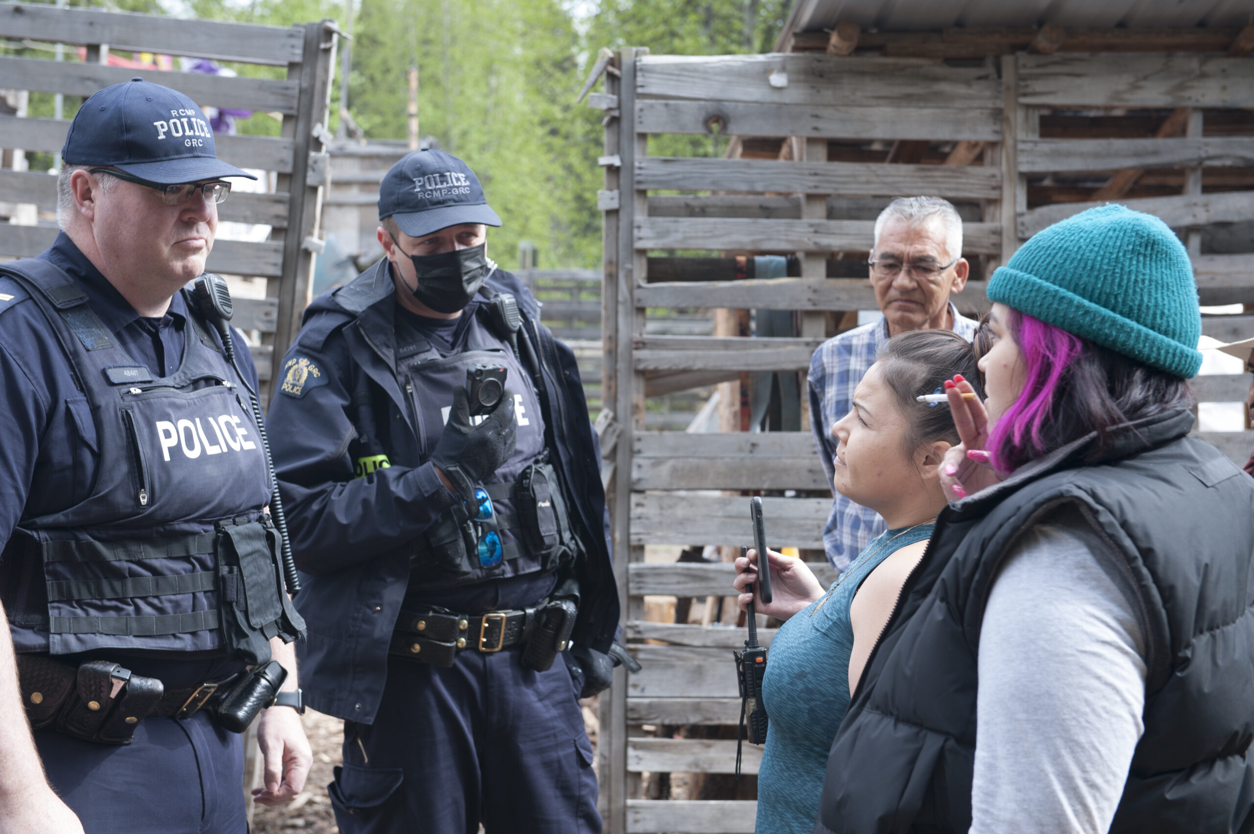 Indigenous land defenders speak with RCMP as a Wet'suwet'en chief watches