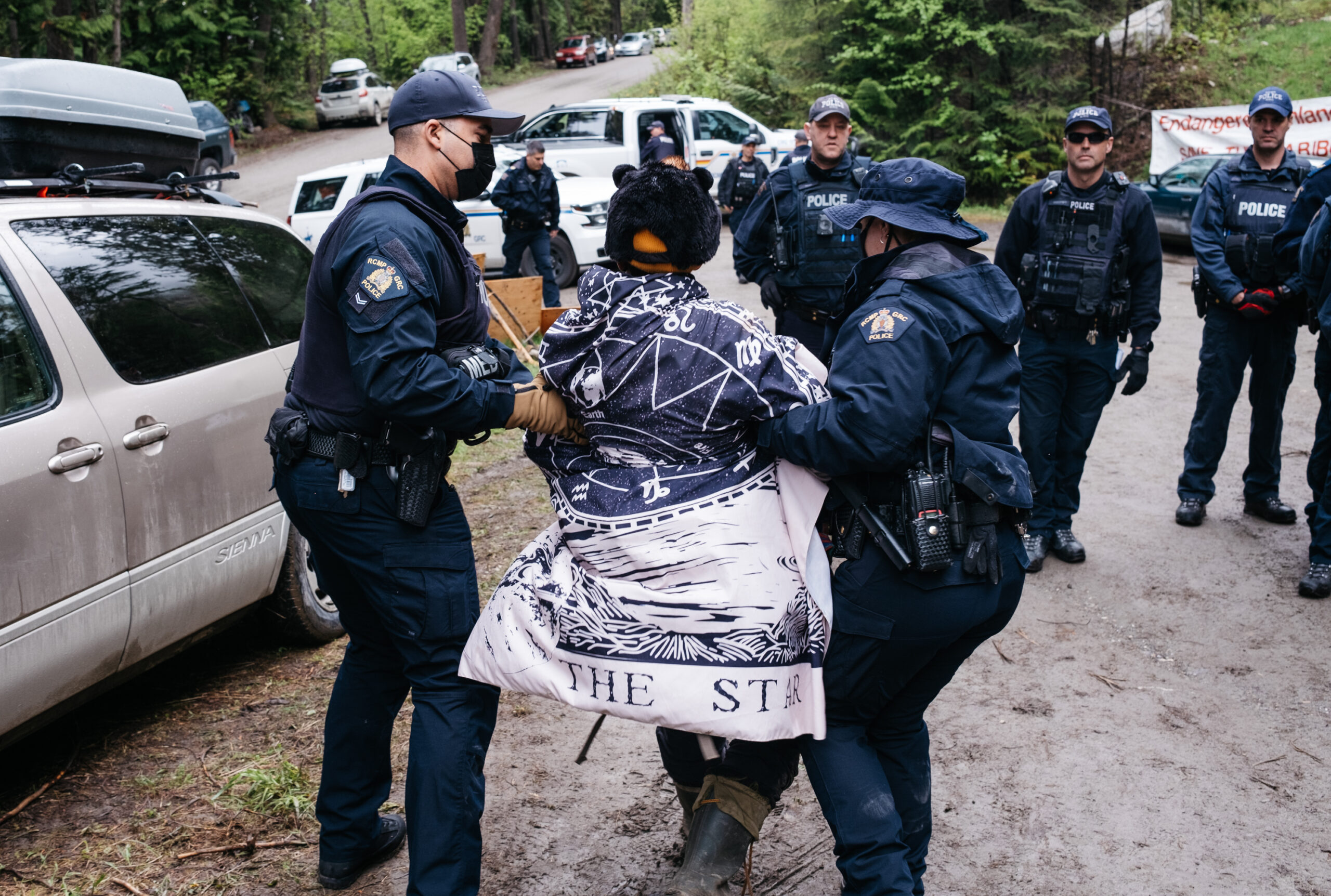 RCMP arrest and remove the protester's designated police liaison representative shortly after arriving to enforce the injunction and break up the camp on the Salisbury Forest Service Road at the north end of Kootenay