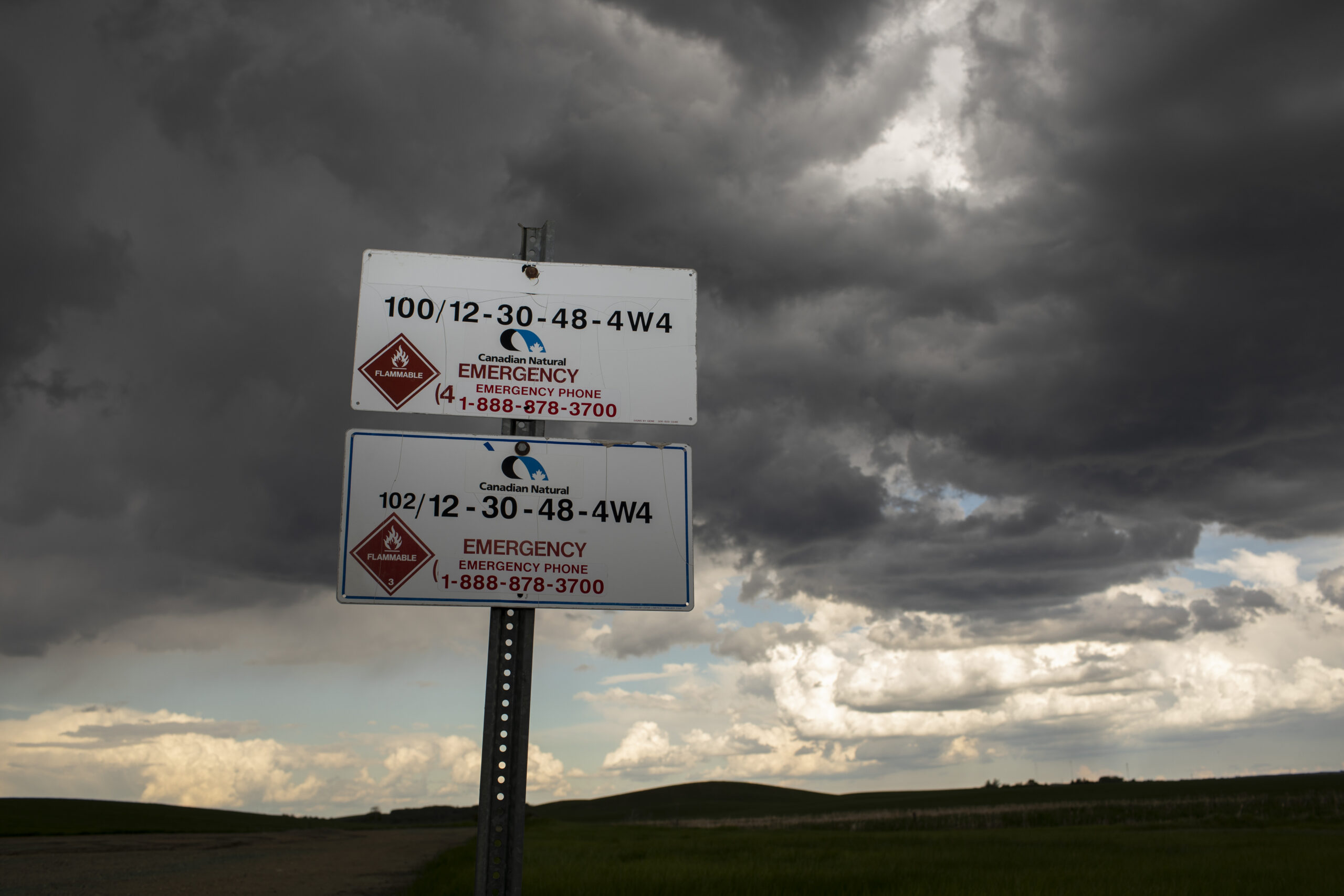 A CNRL sign shows a code corresponding to a well site in Alberta near Lloydminster on June 12, 2022.