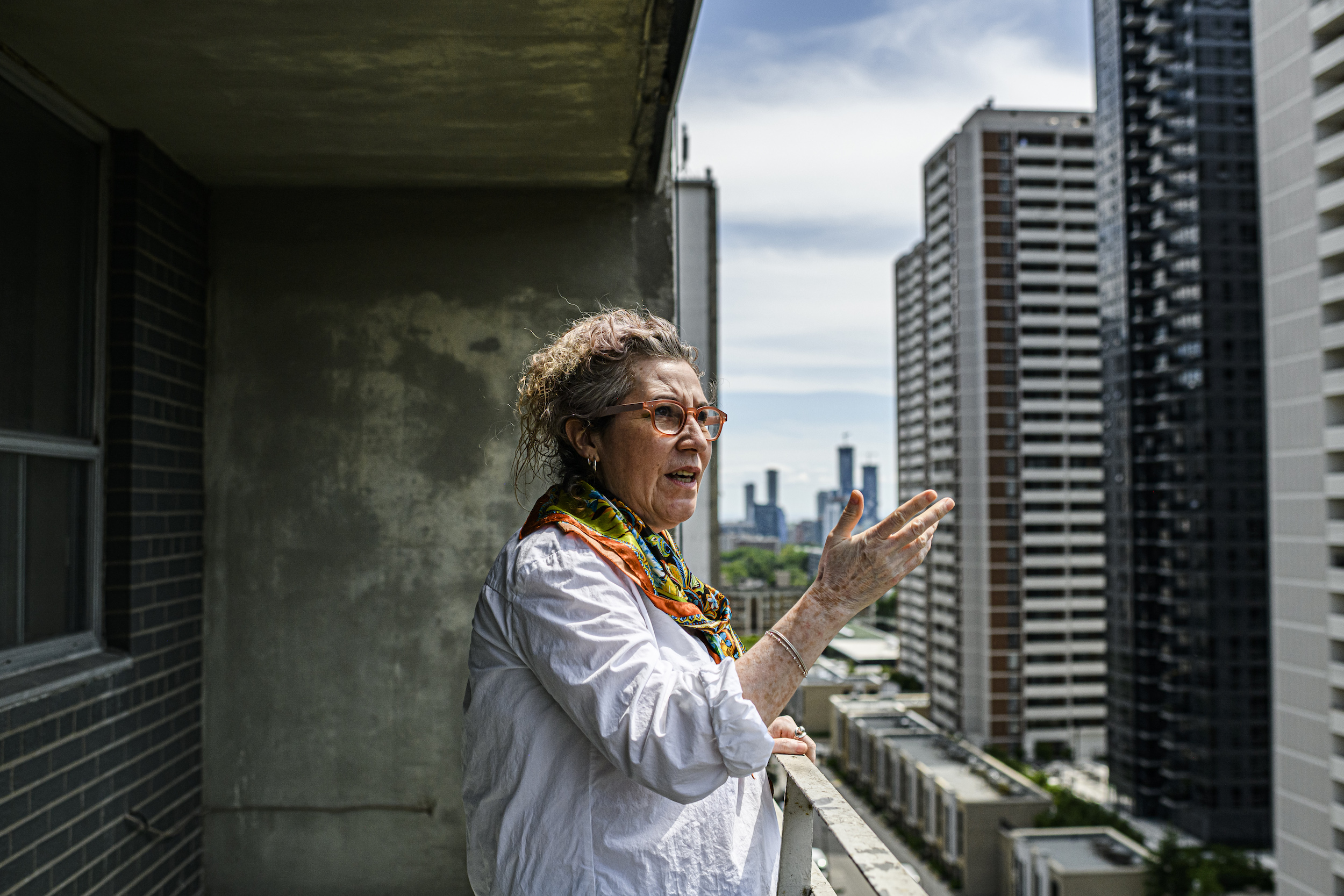 Lidia Ferriera, community animator with Community Resilience to Extreme Weather (CREW), surveys the neighbourhood from Shaheen Kausar’s apartment, in St. James Town, Toronto.
