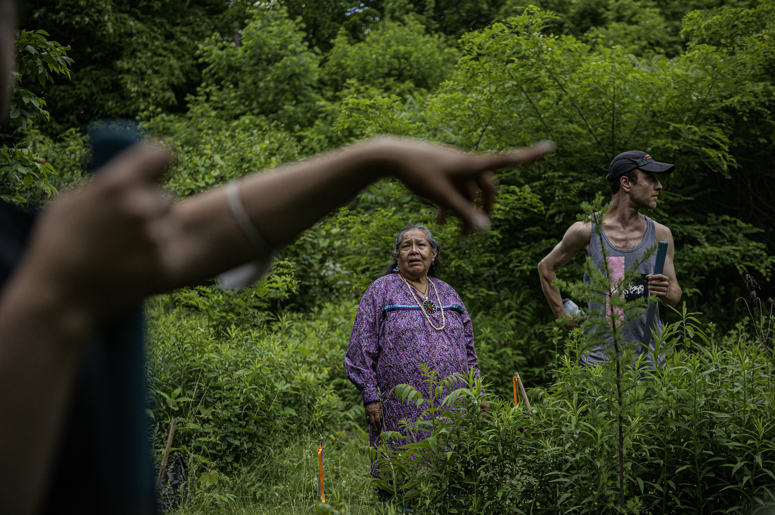 Donna Powless, director of Taiaiako’n Historical Preservation Society (THPS) speaks with Callum Schuster (right) and other members of the Indigenous Land Stewardship Circle while they prepare the ground for planting, in High Park, Toronto