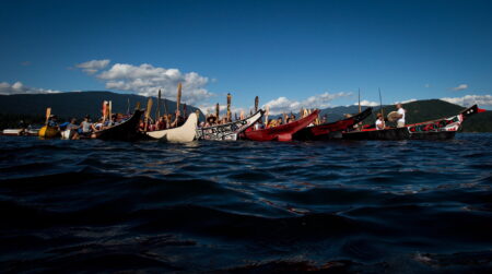 Members of the Squamish and Tsleil-Waututh First Nations gather in canoes on the waters of Burrard Inlet at the Kinder Morgan Burnaby Terminal for a ceremony to show opposition to the $5 billion expansion of the Trans Mountain pipeline, in North Vancouver, B.C., on Saturday September 1, 2012.