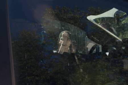 A land defender knocks on the window of an RCMP vehicle on Wet'suwet'en territory.
