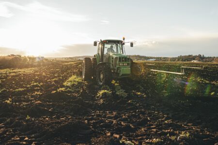 A tractor works a farm field in Ontario