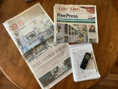 Copy of Winnipeg Free Press on a coffee table with reporter Julia-Simone Rutgers' story on the front page