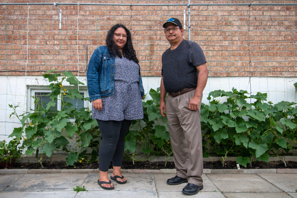 Munawar Ahmed and his daughter Sana in his backyard food garden in Brampton, Ont. Photo: Ramona Leitao / The Narwhal