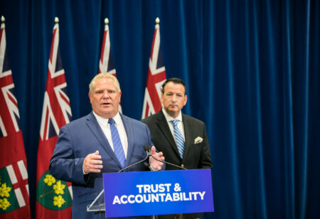 Indigenous Protected and Conserved Areas: Premier Doug Ford speaks at a podium with Greg Rickford, now the minister of Indigenous Affairs and Northern Development, standing behind him