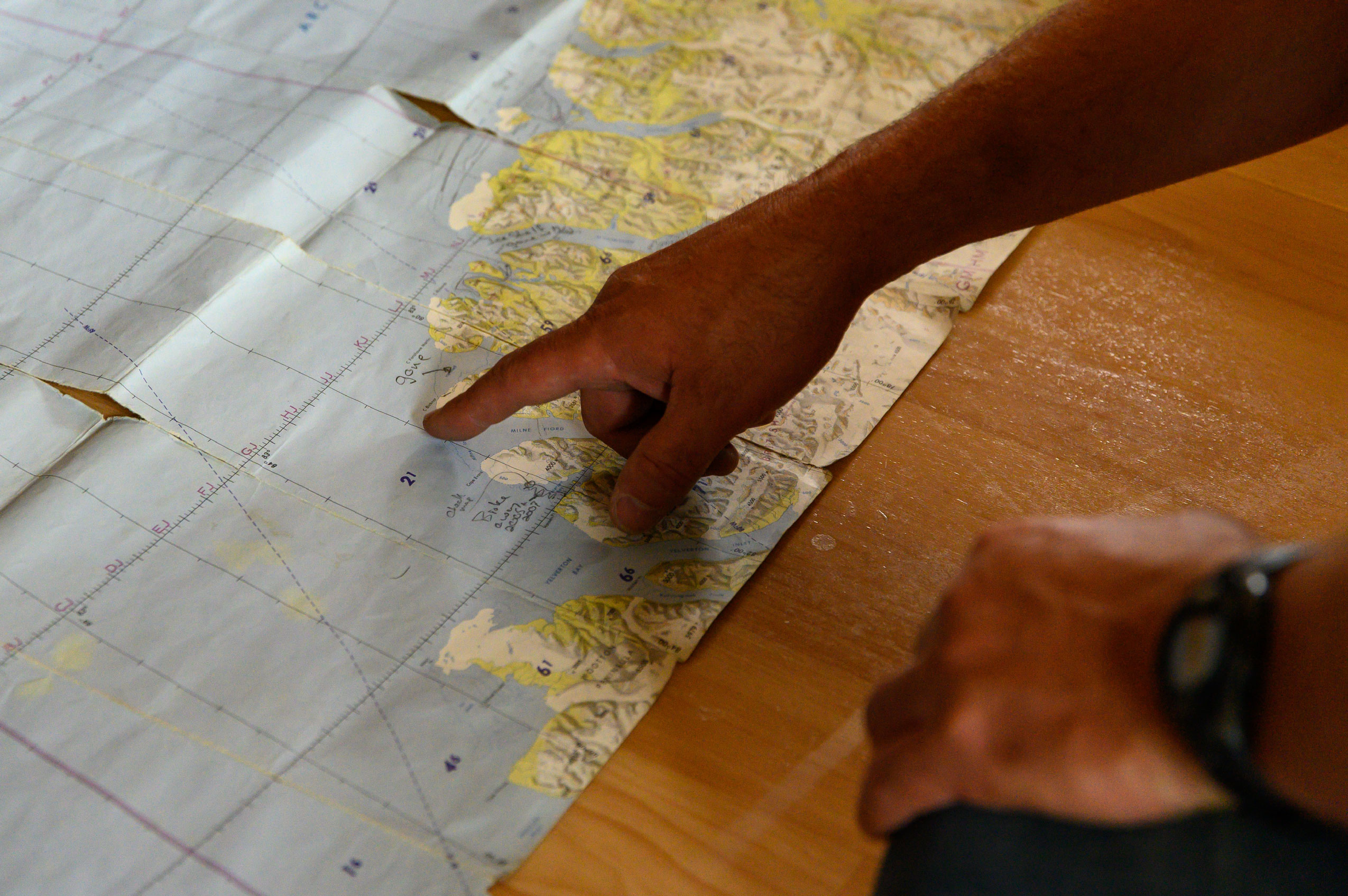 During a pre-trip meeting in Resolute, glaciologist Derek Mueller points to a map of Ellesmere Island, complete with notes indicating when various ice shelves in the region collapsed. The shelves are land-fast platforms of ice flowing away from a glacier to the opening of the inlet on the ocean. A century ago, the northern coast of Ellesmere was wrapped in a continuous edge of ice. Now, only bits and pieces of various shelves remain in the island’s deep fiords.