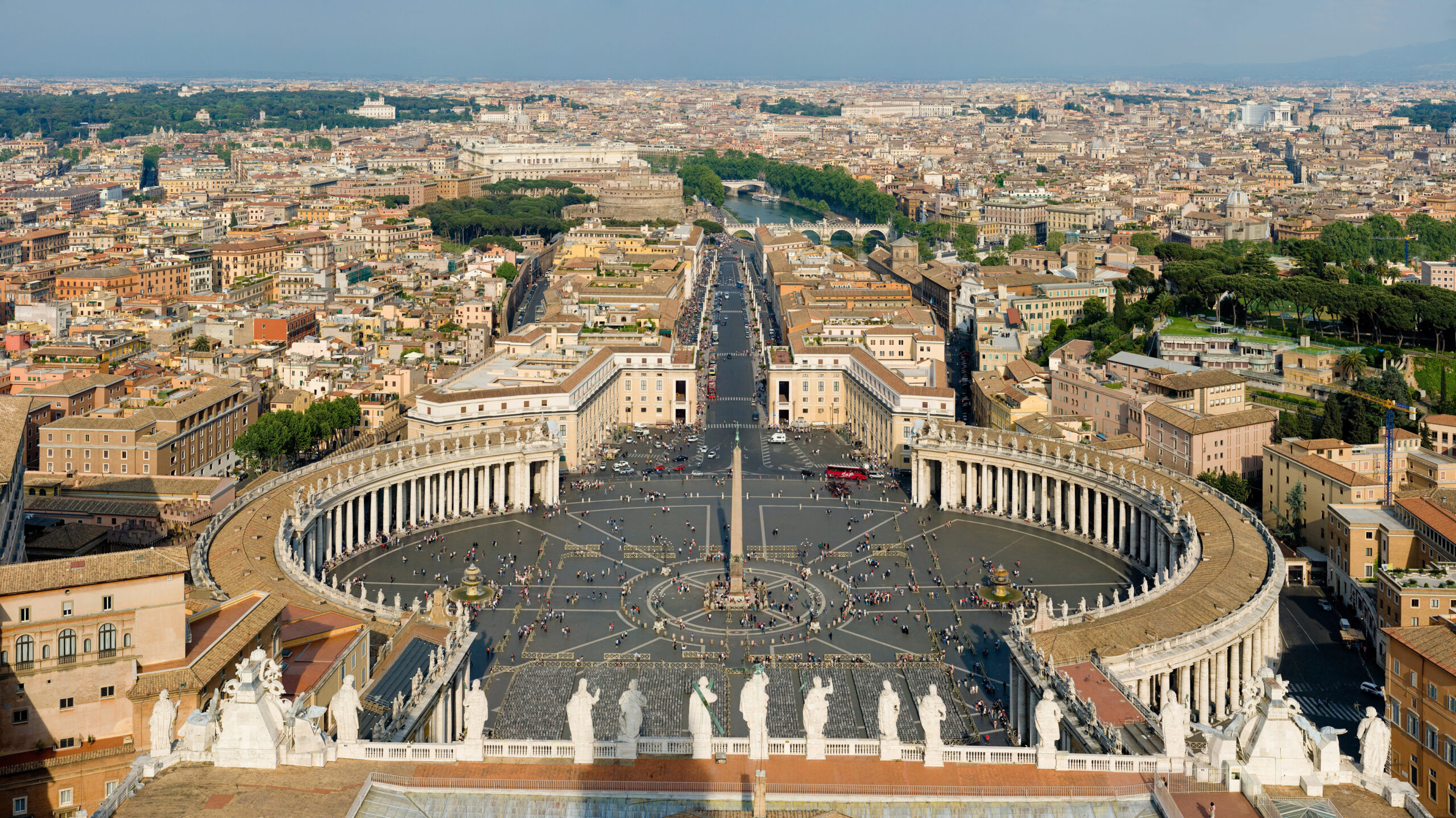 Vatican City in Rome, Italy is seen from above looking down upon St. Peter's Square on a sunny day.