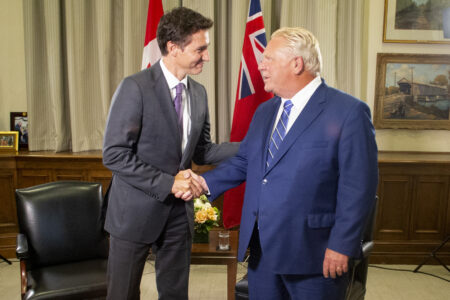 Justin Trudeau shakes hands with Doug Ford at Queen's Park in August 2022