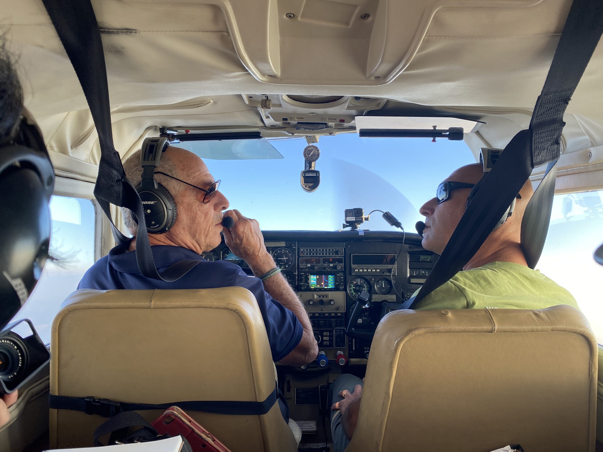 Photo of pilot and co-pilot on a small Cessna flight.
