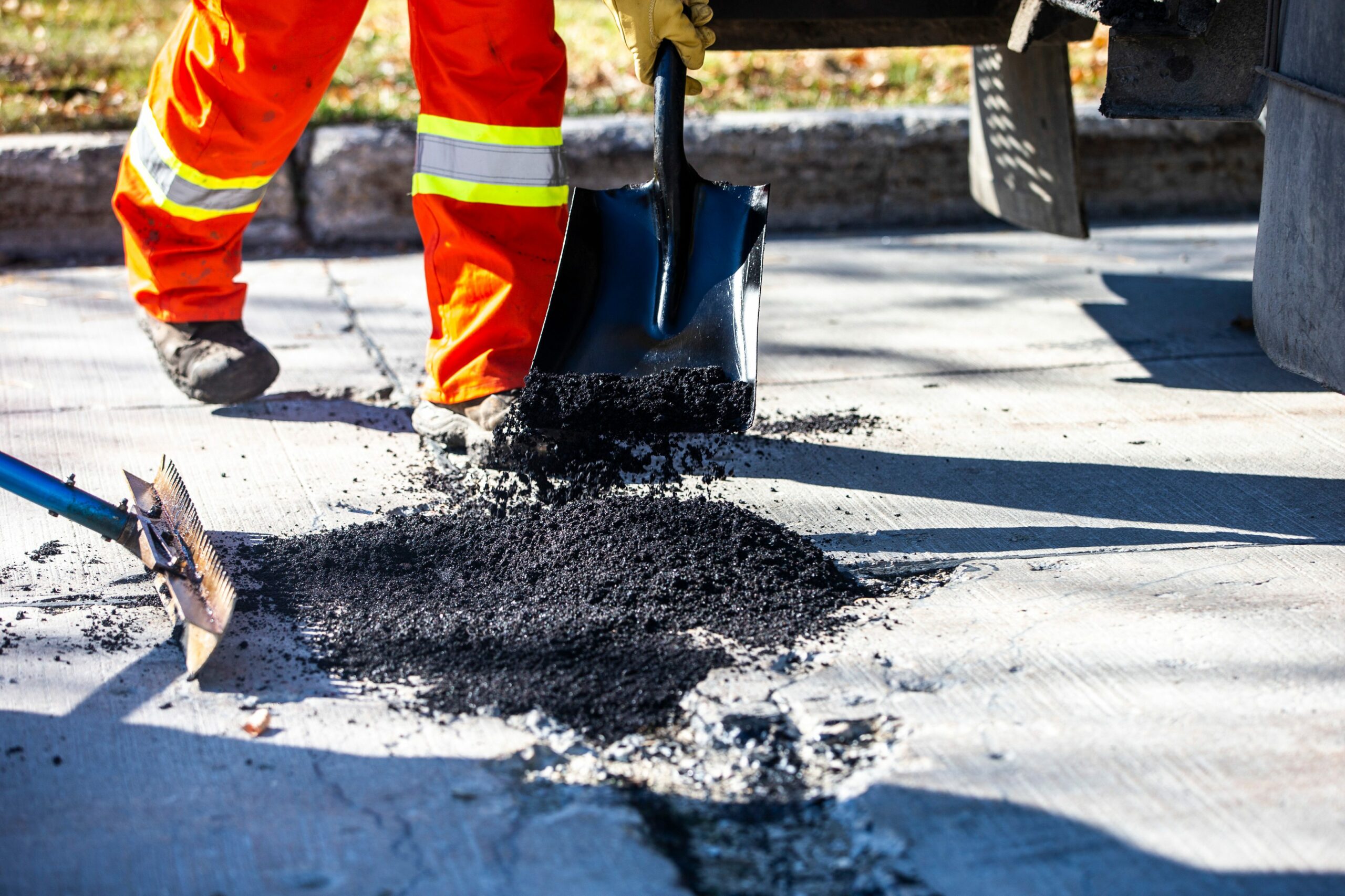 Coarse asphalt mix is shoveled into a Winnipeg pothole