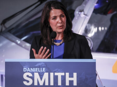 Danielle Smith speaks at a podium