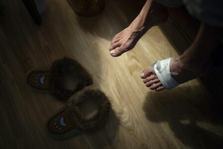 A man's bandaged feet and moccasins