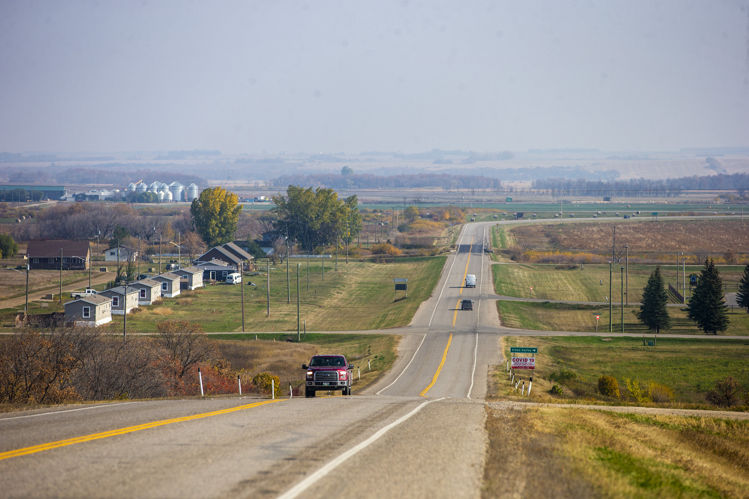 View of highway between houses and farmland