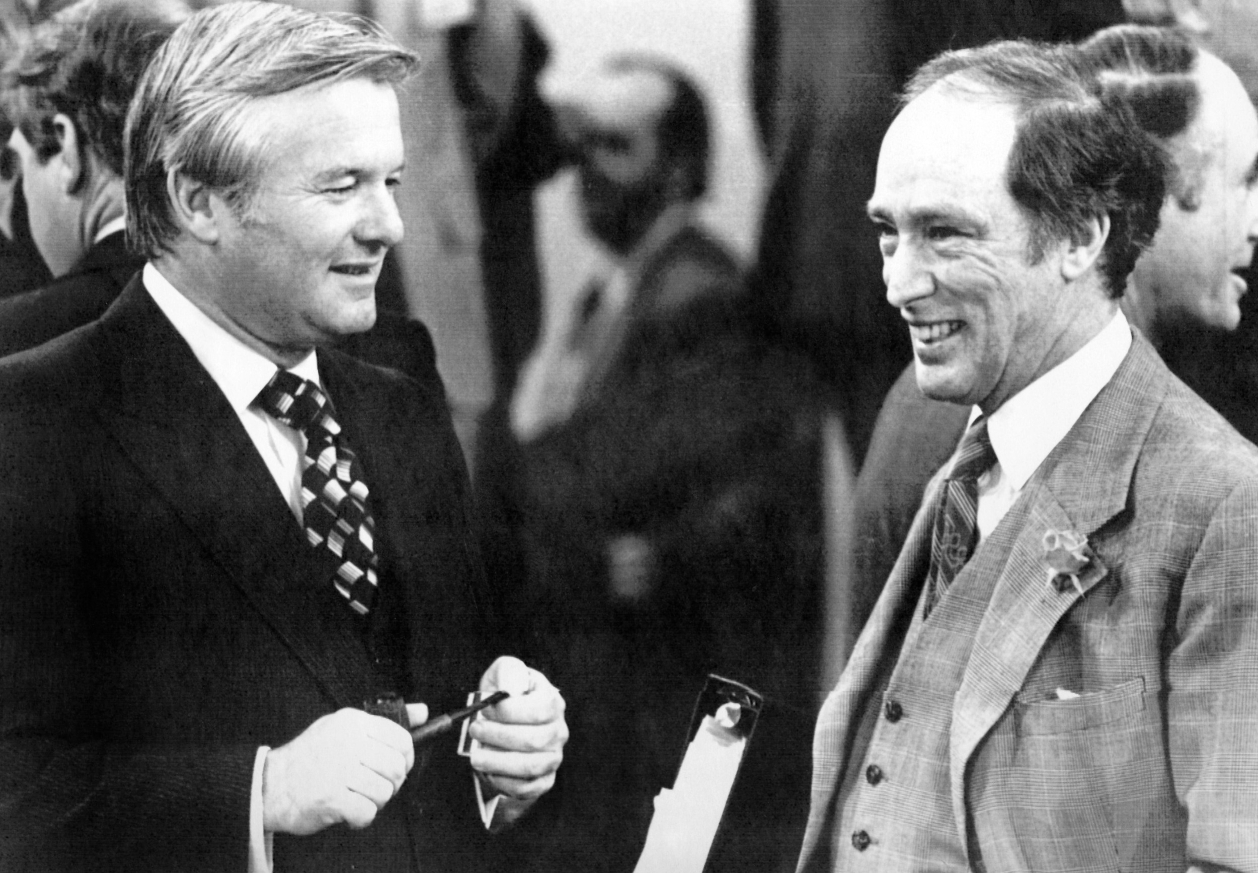 A black and white photo of Bill Davis and Pierre Trudeau in conversation