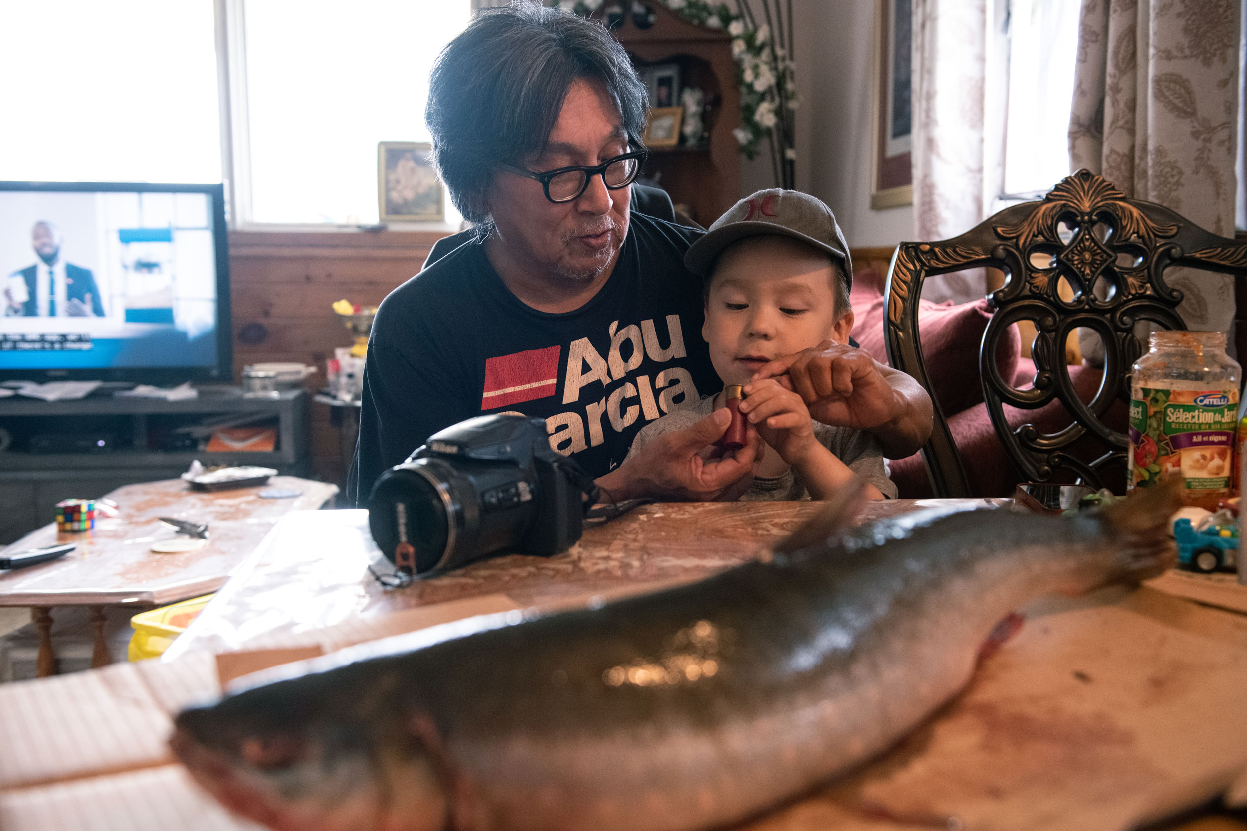 Arviat hunter Gordy Kidlapic hopes to teach his young grandson, Victor, how to harvest from and care for the changing environment around them.