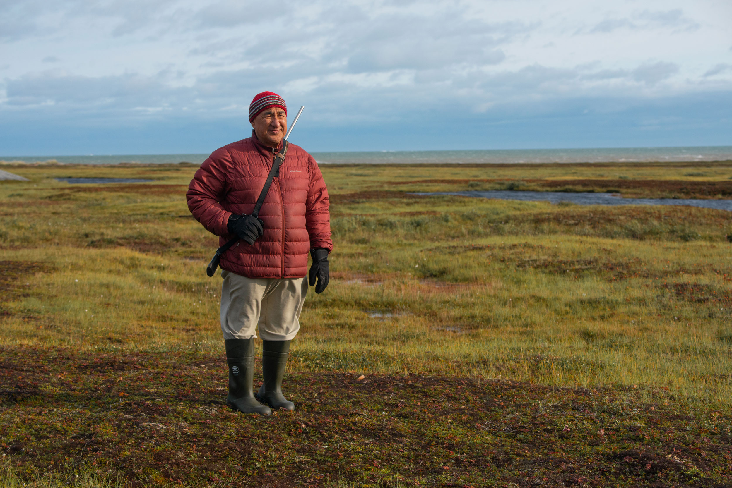 Joe Karetak keeps watch for polar bears on the tundra near Arviat.