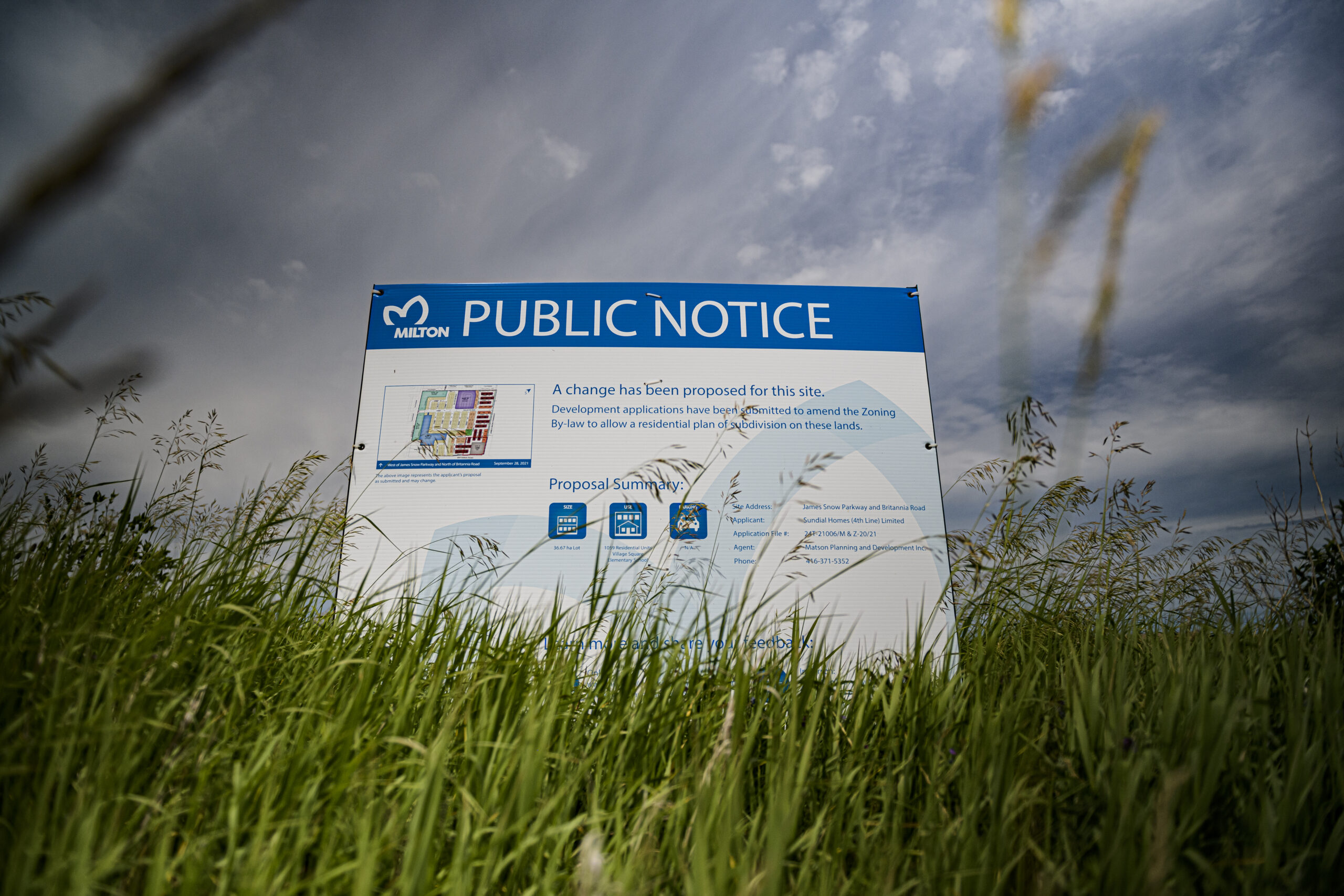 A public notice sign in Halton Region farmland that outlines a new development