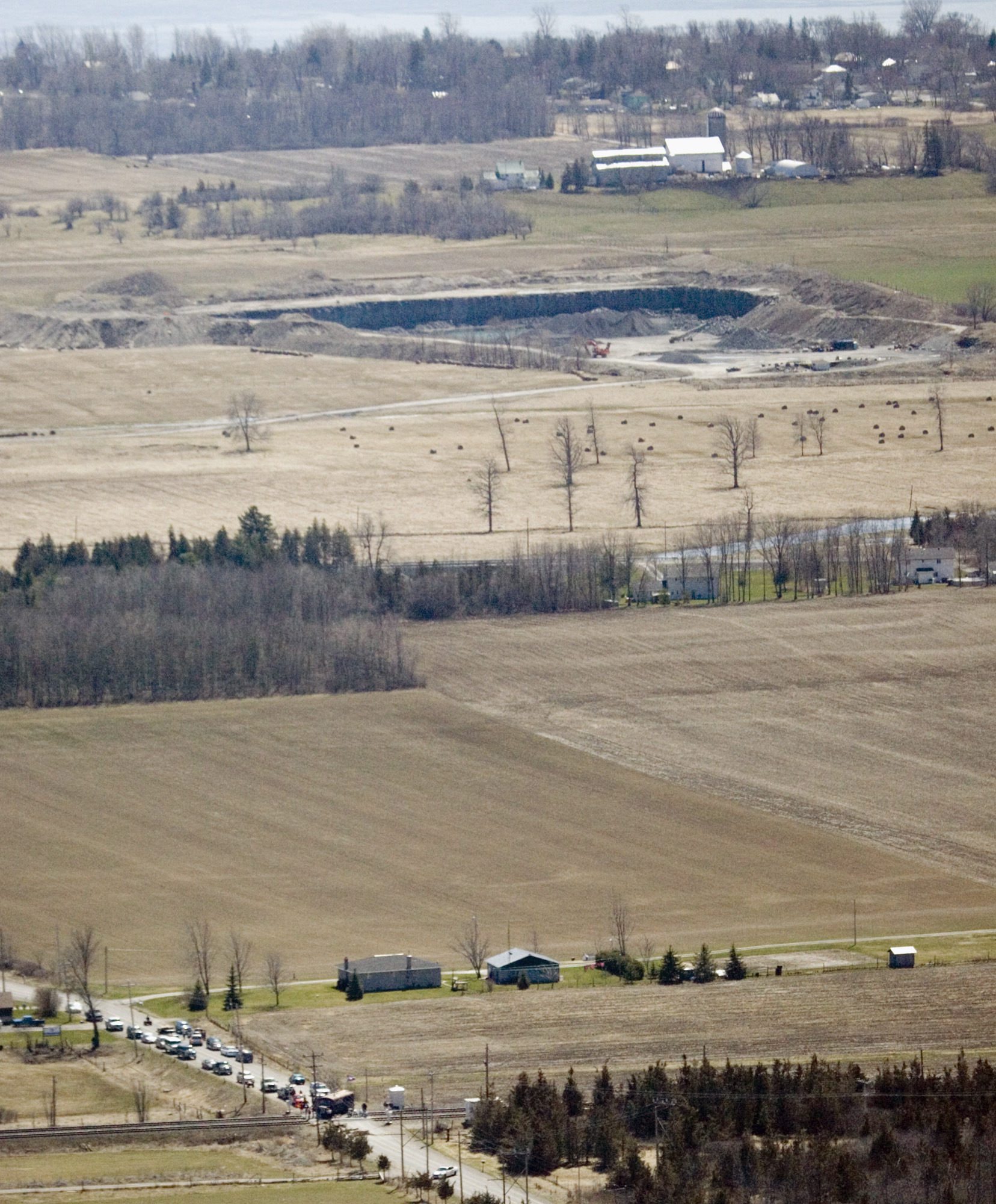An aerial view of a quarry pit amid farmland