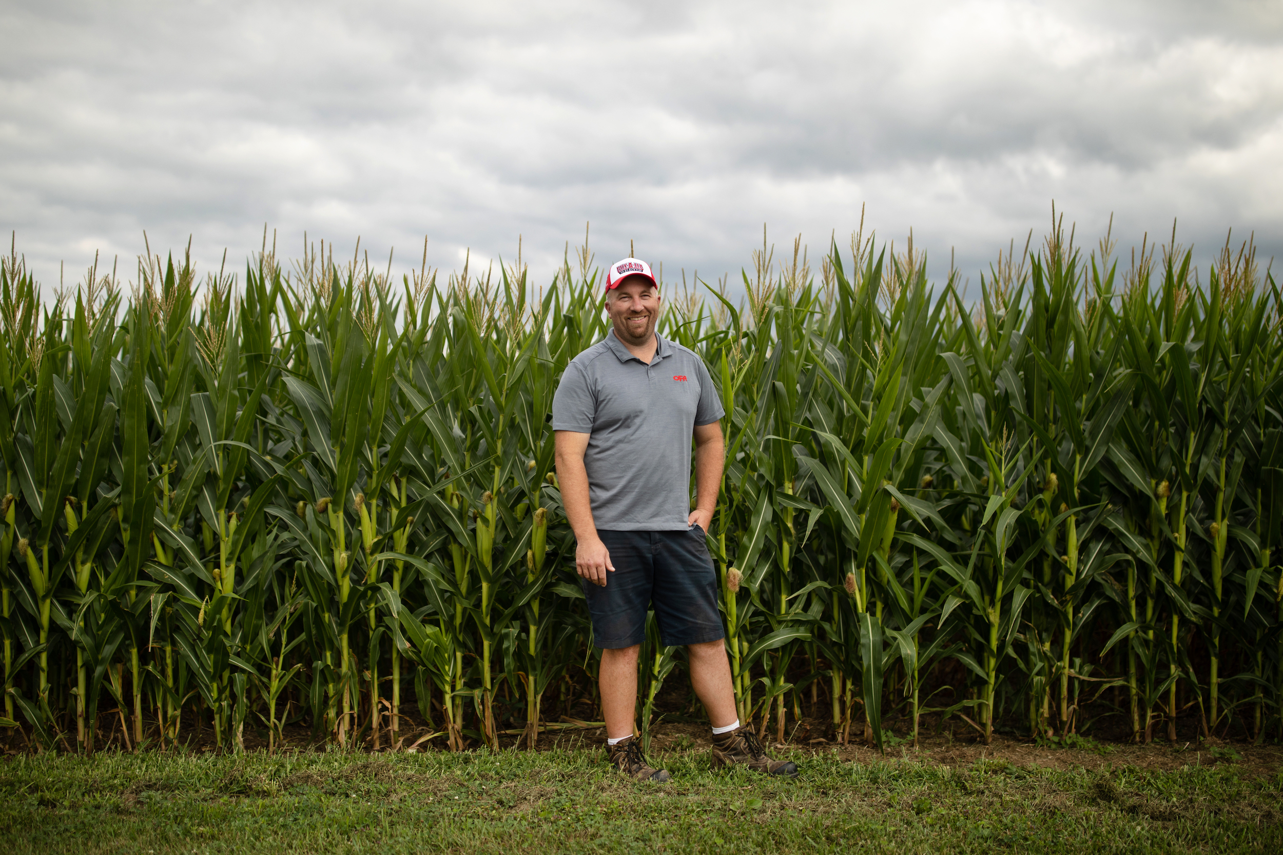 Drew Spoelstra stands in a corn field on his farm in Binbrook, Ontario, Tuesday, August 9, 2022.