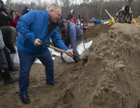 Ontario Premier Doug Ford helps fill sandbags as he visits flooded areas on Friday, April 26, 2019 in Ottawa.