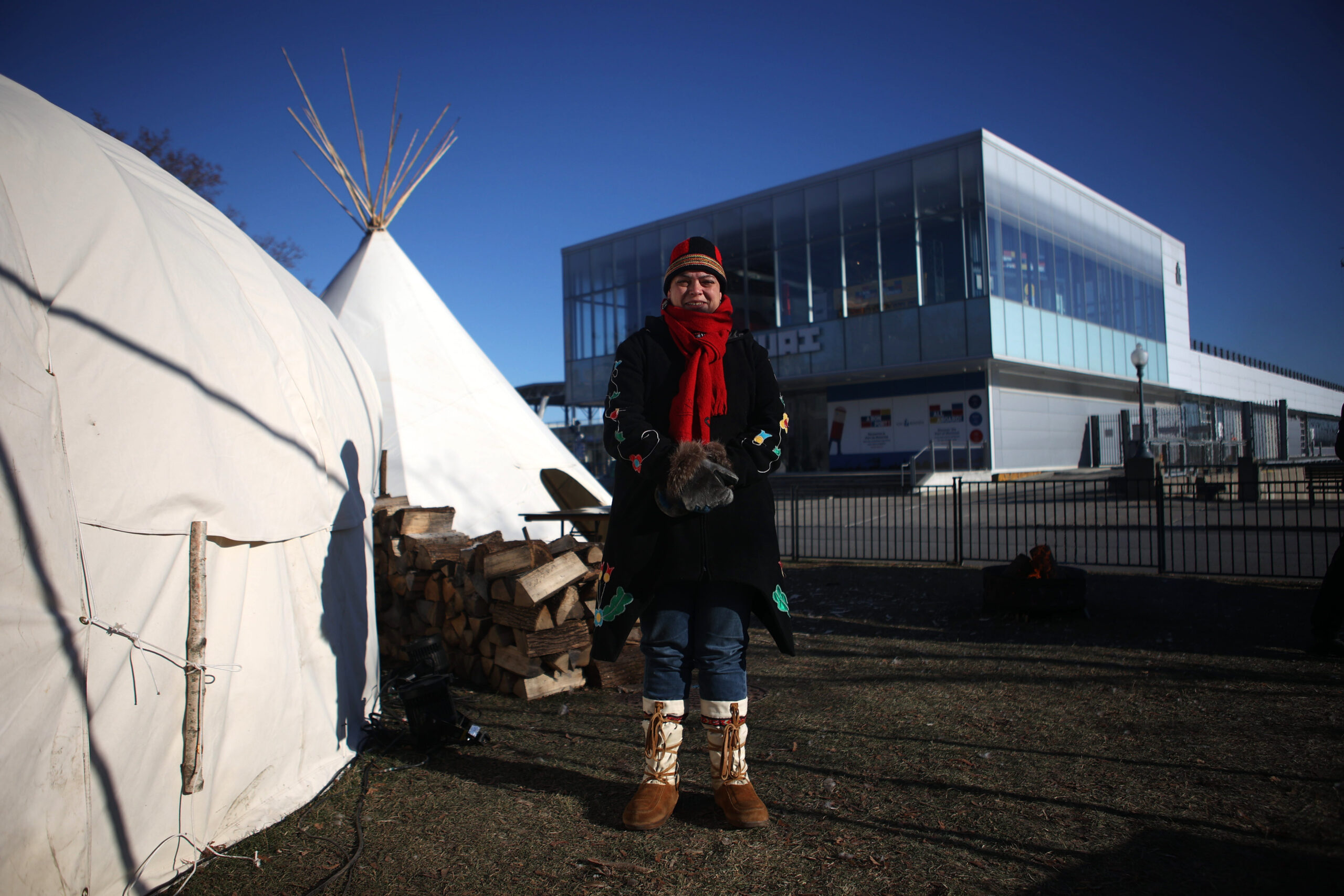 Valérie Courtois at COP15 in the Indigenous Village, bundled up in a red scarf and tuque on a sunny winter day.