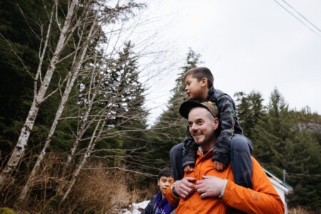 Northwest B.C. reporter Matt Simmons with two Nisg̱a’a youth, one on his shoulder.