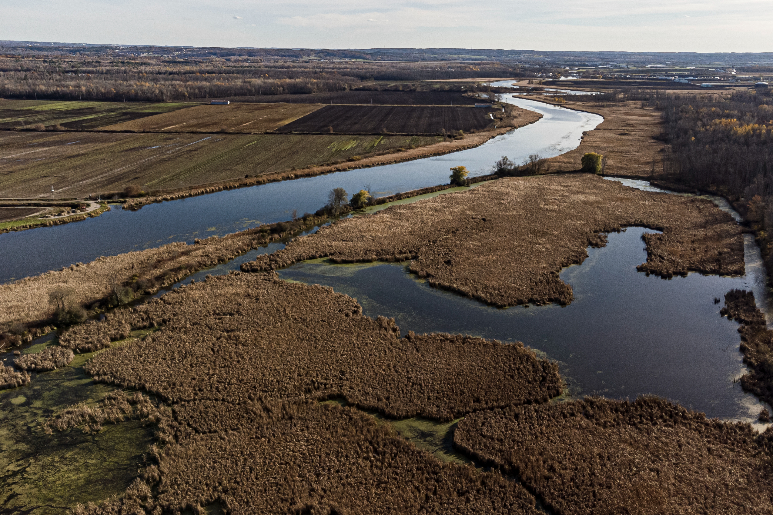 An aerial view of a bend in the Holland River and farmland