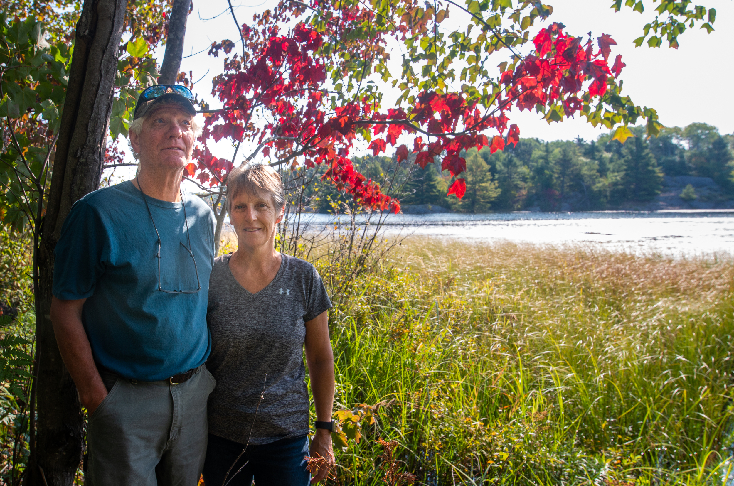 Jim and Rhonda Kirby pose at the edge of a wetland