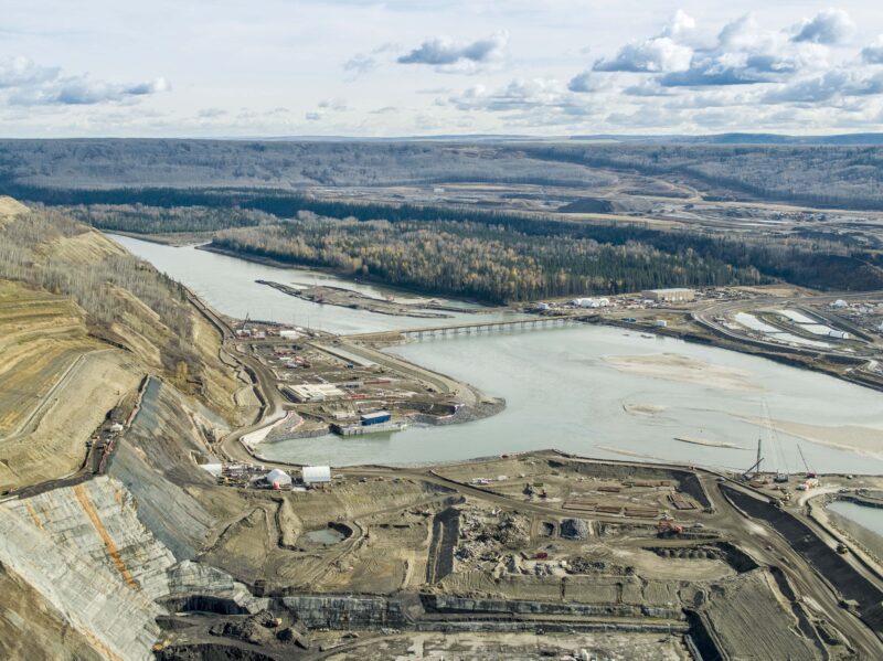An overhead view of BC Hydro Site C dam construction along the Peace River.