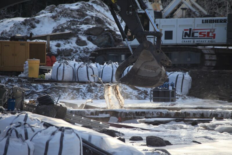 Heavy machinery working at a Coastal GasLink river crossing in winter