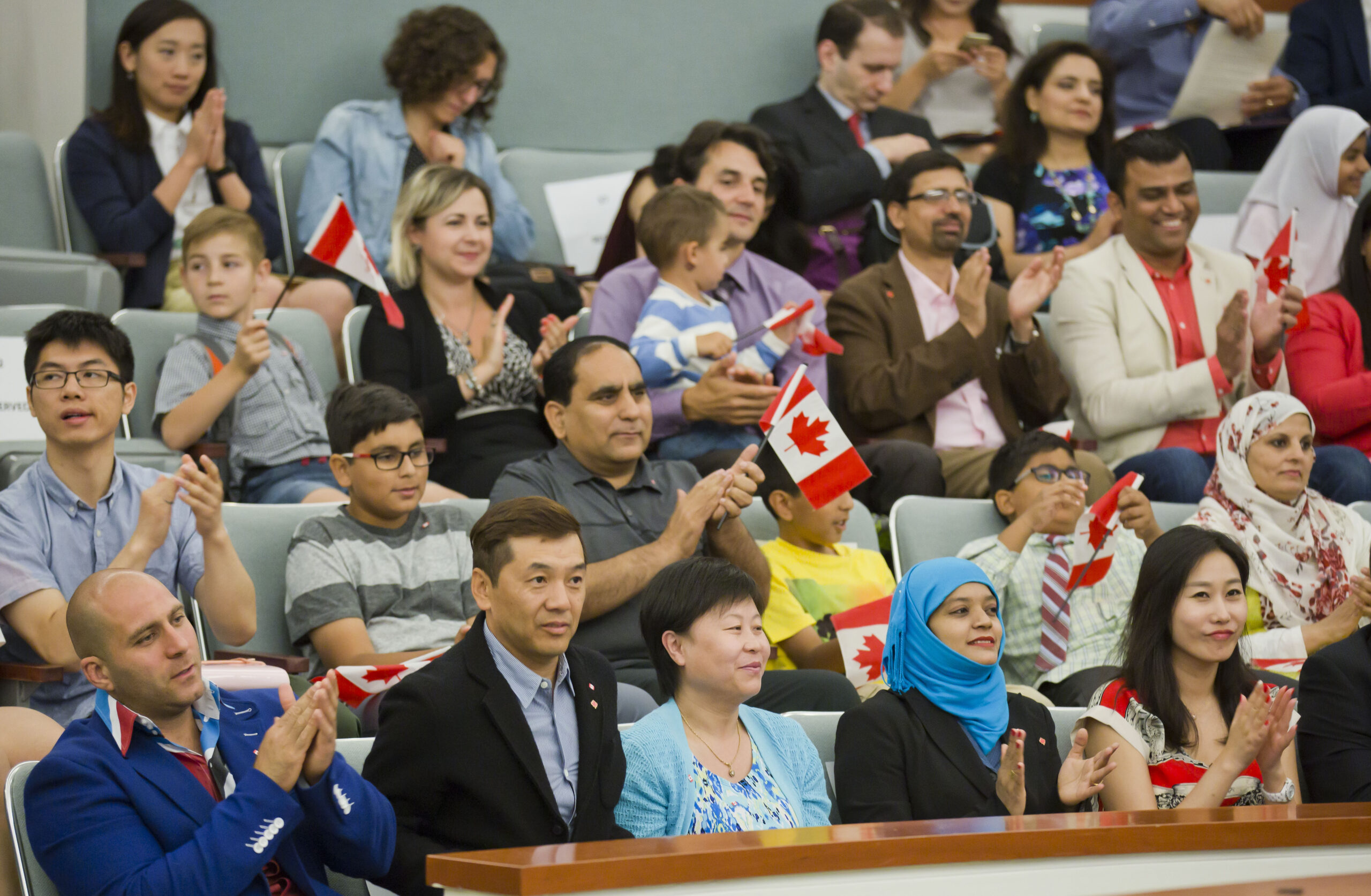 Newcomes wait to take their oath at a citizenship ceremony in Markham, Ont. in 2016