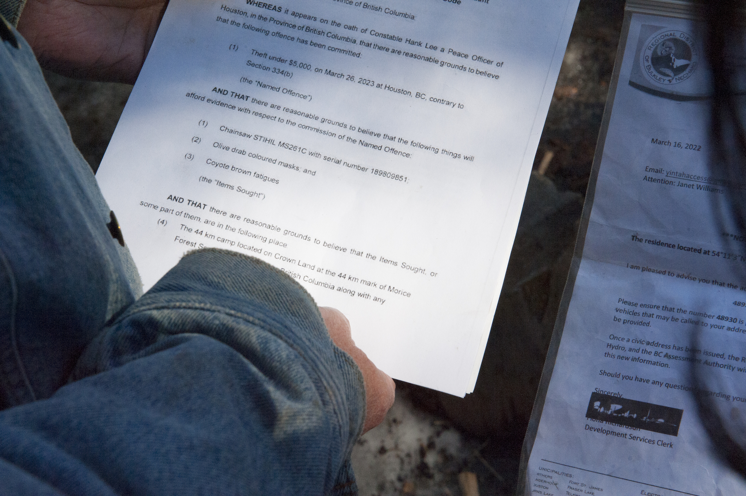 A Wet'suwet'en Hereditary Chief holds a copy of a search warrant