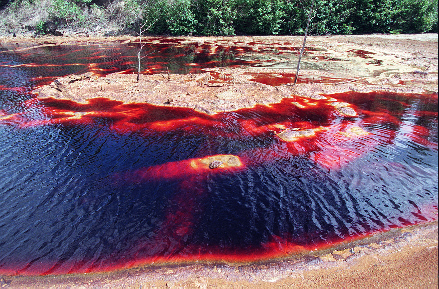 Red water caused by the tailings of a closed copper mine near Sherridon, Manitoba in 1999