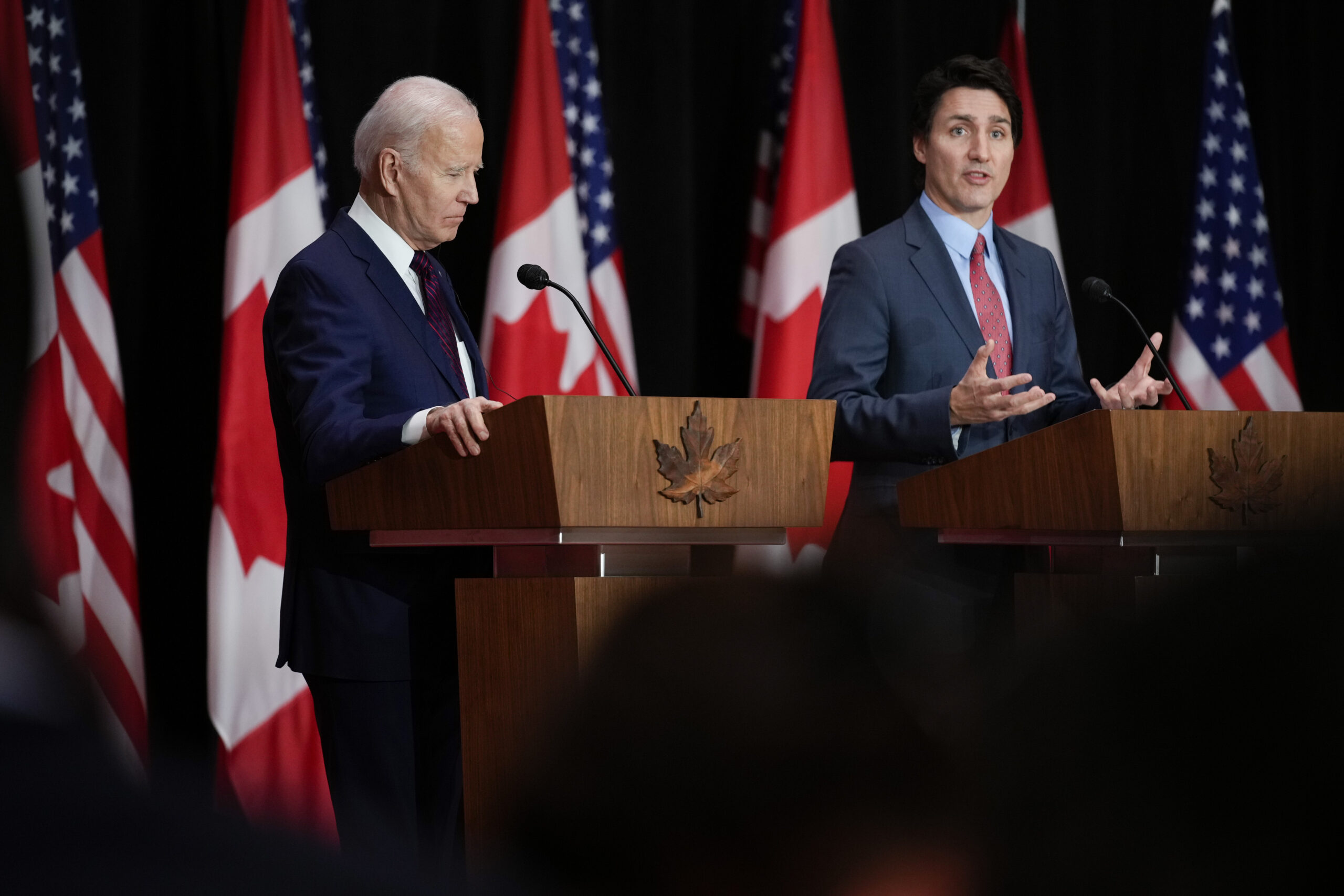 President Joe Biden listens as Canadian Prime Minister Justin Trudeau speaks during a news conference.