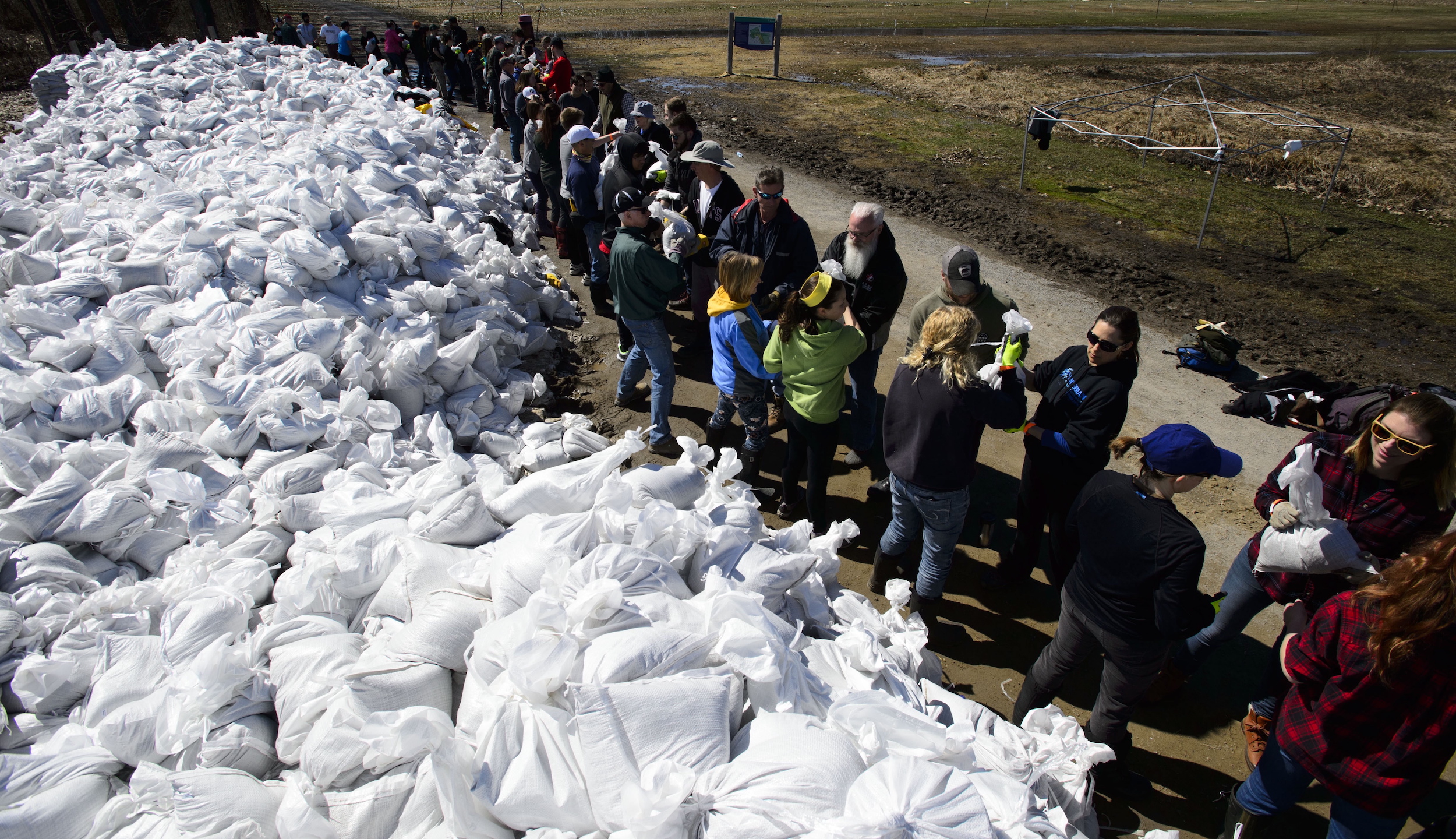 Students from Terry Fox Elementary School join fellow volunteers in a sand bag assembly line as they fight to hold back floodwaters on the Ottawa River in 2019. One solution to reducing Canada's reliance on the military for disaster relief would be training local volunteers.