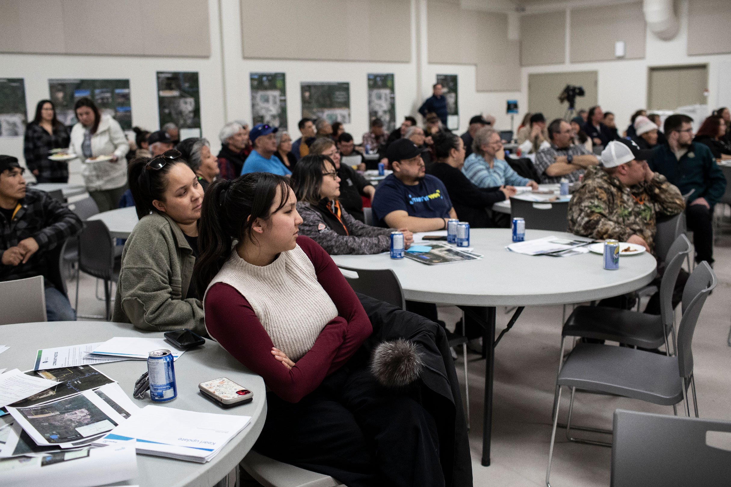 Community members watch speakers at a meeting with Imperial Oil in Fort Chipewyan 