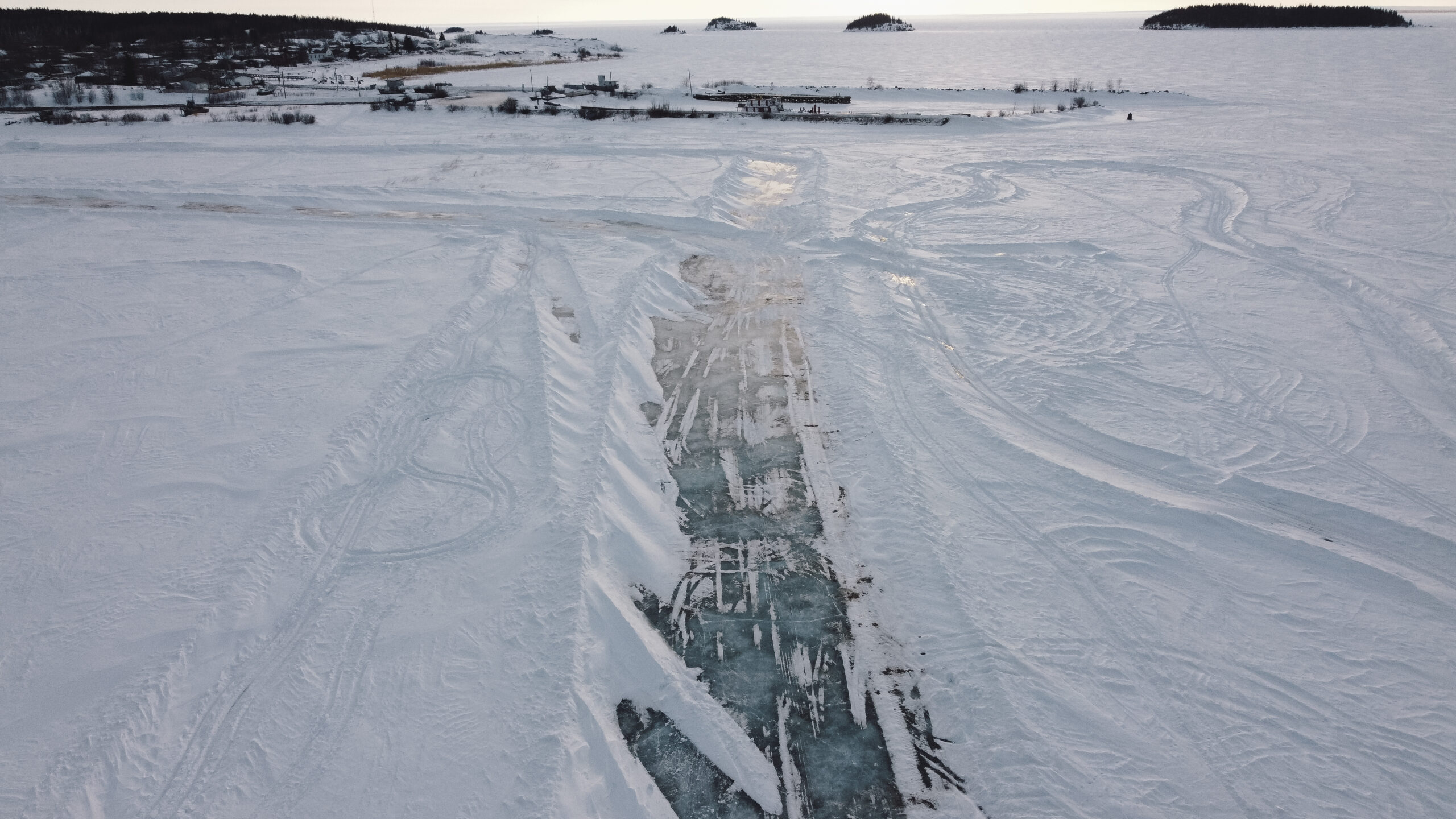 An aerial view of an ice road leading into Fort Chipewyan.