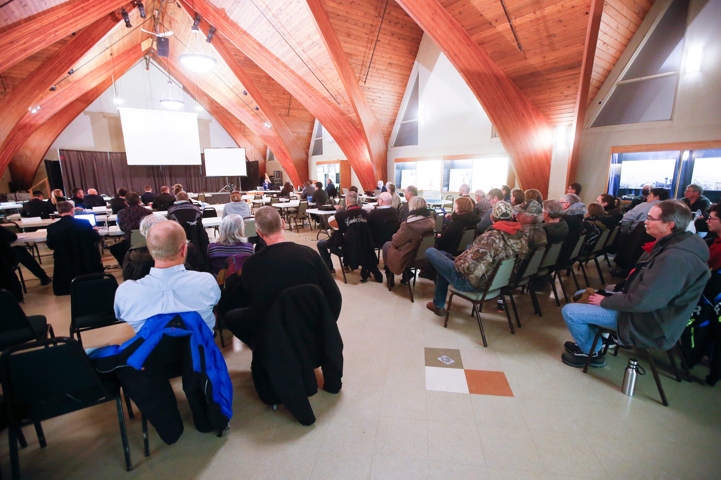 Dozens of people sit in a hall at the Mennonite Heritage Village in Steinbach, Manitoba to take part in a Clean Environment Commission hearing regarding Sio Silica's proposed sand mine
