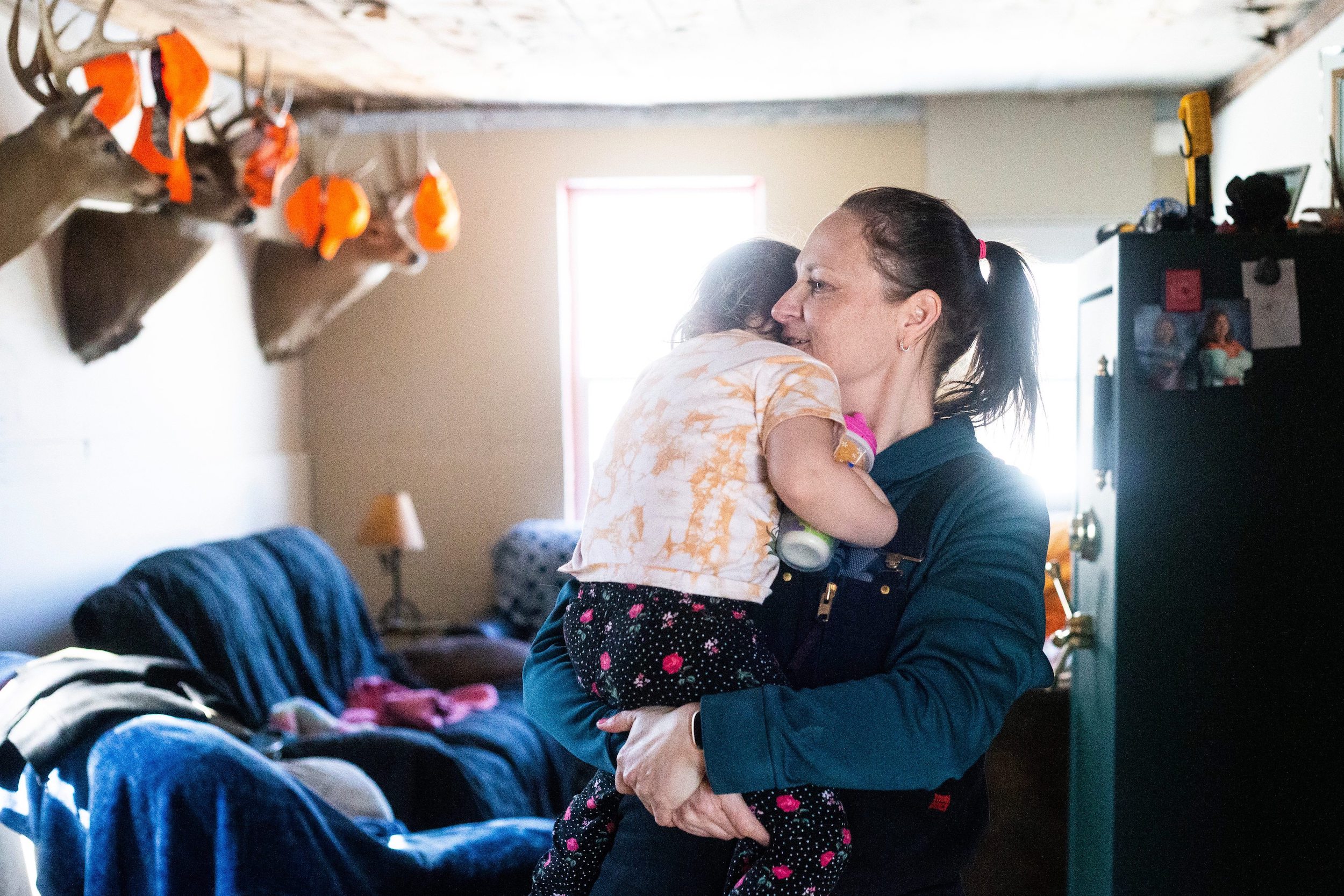 Georgina Mustard cradles her youngest child, Callie, in the living room of their Vivian, Manitoba home