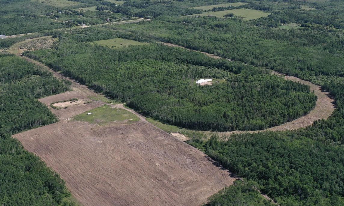 An aerial view of land clear cut for a silica sand processing facility and accompanying rail loop near Vivian, Manitoba